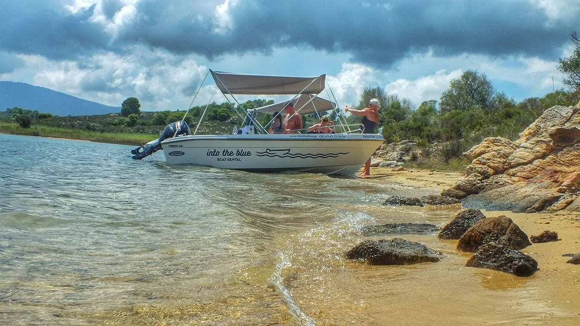 Family on a beach reached by boat Halkidiki